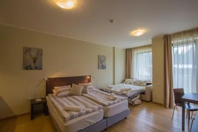 a bedroom with a large bed and a couch at Euphoria Club and Resort Rental in Bŭrduche