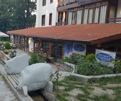 a restaurant with two large rocks in front of a building at Mountain View Resort - Apartment B45 in Bansko