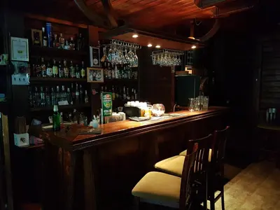 a bar in a pub with a counter and chairs at Mountain View Resort - Apartment B45 in Bansko
