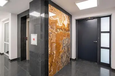 a lobby with a door and a wall with a painting at 