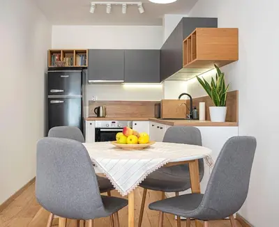 a kitchen with a table with chairs and a bowl of fruit at 
