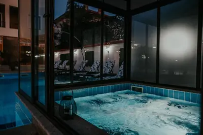 a hot tub in the middle of a building with windows at Слънчевите Къщи in Banya