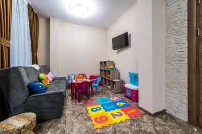 a living room with a couch and a table at Слънчевите Къщи in Banya