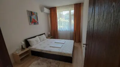 a small bedroom with a bed and a window at White grapes apartment in Petrich