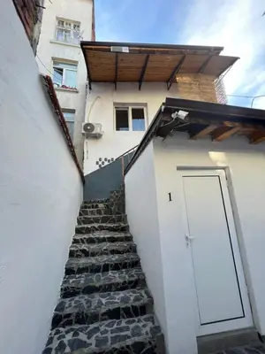 a stairway leading up to a white building with a door at The rainbow 4 in Sofia