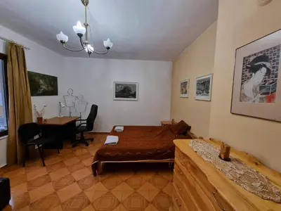 a bedroom with a bed and a desk in it at Tsar Simeon, 2 bedroom, living room and fireplace in Sofia