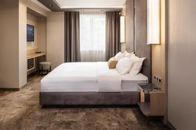 a hotel room with a large bed and a desk at -- ESTE PARK HOTEL -- part of Urban Chic Luxury Design Hotels - Parking & Compliments - next to Shopping & Dining Mall Plovdiv in Plovdiv