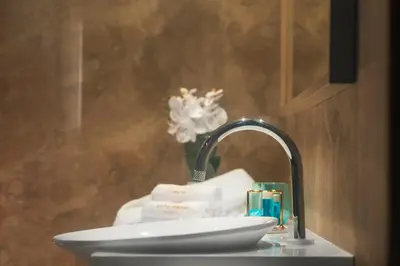 a bathroom sink with a faucet and a toilet at -- ESTE PARK HOTEL -- part of Urban Chic Luxury Design Hotels - Parking & Compliments - next to Shopping & Dining Mall Plovdiv in Plovdiv