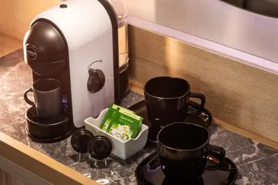 a counter with three cups and a coffee maker at -- ESTE PARK HOTEL -- part of Urban Chic Luxury Design Hotels - Parking & Compliments - next to Shopping & Dining Mall Plovdiv in Plovdiv
