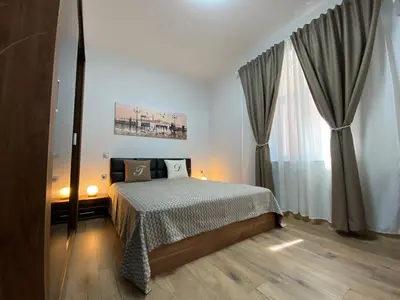 a bedroom with a bed and a large window at La Luna - High-end 2BD Flat in the TOP centre by Flat Mаnager in Sofia