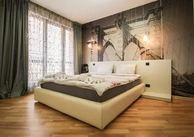 a bedroom with a bed in a room with a wall at Trendy & Deluxe Apartment by Flat Mаnager in Plovdiv