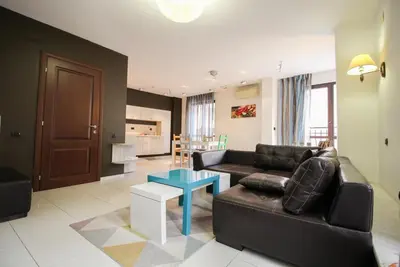 a living room with a black couch and a table at Trendy & Deluxe Apartment by Flat Mаnager in Plovdiv