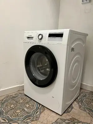 a washing machine is sitting in a room at The rainbow 5 in Sofia