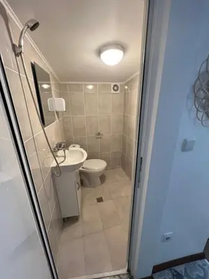 a bathroom with a shower and a toilet and a sink at The rainbow 5 in Sofia
