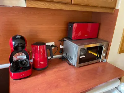 a kitchen counter with a microwave and a coffee maker at Allure in Pirin Golf in Razlog