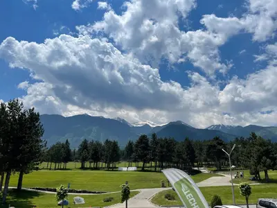a view of a park with mountains in the background at Allure in Pirin Golf in Razlog