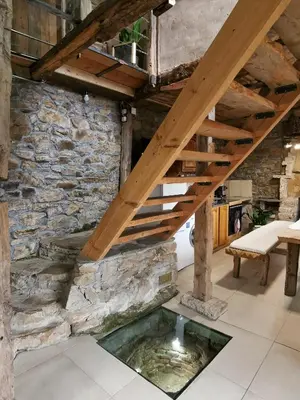 a living room with a pond under a wooden stairs at Вила 'Гнездото', Villa 'The nest', Rhodope mountains, Banite in Vishnevo