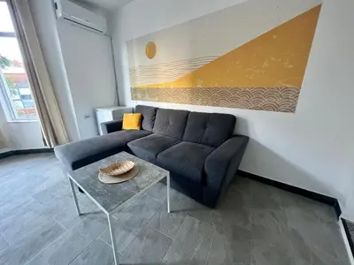 a living room with a couch and a table at The rainbow 3 in Sofia
