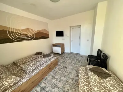 a room with two beds and a television in it at The rainbow 3 in Sofia