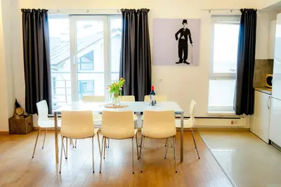 a dining room with a white table and chairs at Saint George Palace Deluxe Collection in Bansko