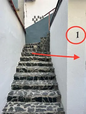 a stairway with a red arrow pointing to a stairway with a stairway at The rainbow 1 & free motorcycle parking in Sofia