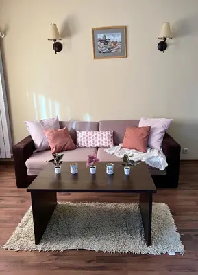 a living room with a couch and a coffee table at Penthouse at Dream Bansko in Bansko