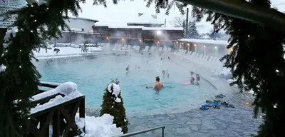 a group of people in a swimming pool in the snow at Penthouse at Dream Bansko in Bansko