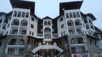 a large building with white and black at Апартамен в Манастира 3 in Smolyan