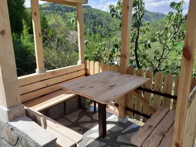 a wooden table on a porch with a view at Cozy Home in Ardino in Ardino
