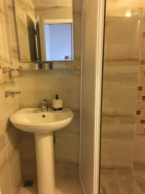 a bathroom with a white sink and a shower at Cozy Home in Ardino in Ardino