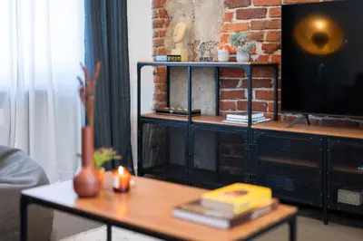 a living room with a tv and a coffee table at Lozenets Modern Apartment Tranquil & Central in Sofia
