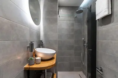 a bathroom with a sink and a shower at Lozenets Modern Apartment Tranquil & Central in Sofia