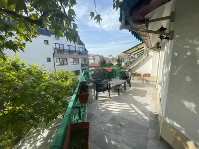 a balcony of a building with a table and chairs at Central Studio with Lovely Terrace & Free street Parking in Plovdiv