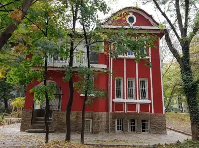 a red and white building with trees in front of it at Top Center Studio 1 in Sofia