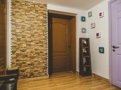 a room with a brick wall next to a door at Top Center Apartment 2 in Sofia