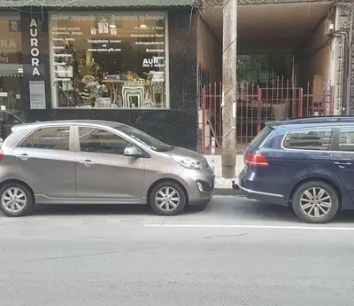 two cars parked on the side of a street at Top Center Apartment 2 in Sofia