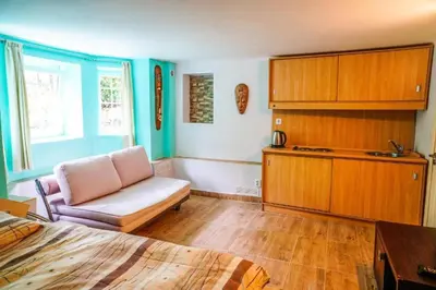 a room with a bed and a chair and a cabinet at Top Center Studio 3 in Sofia