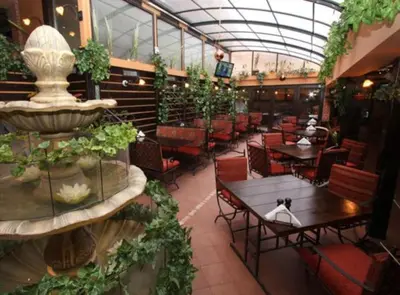 a restaurant with tables and chairs and a fountain at Top Center Apartment 4 in Sofia