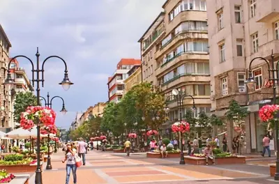 a city street with buildings and people walking down a street at Top Center Apartment 4 in Sofia