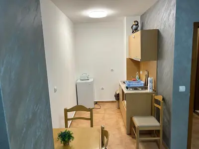 a small room with a kitchen with a table and chairs at Комплекс Замъка 2 ап 301 in Pamporovo