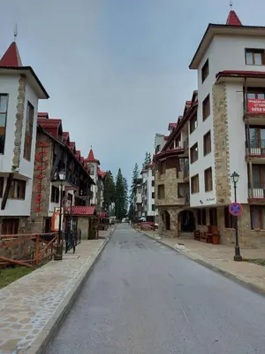 an empty street in a town with buildings at Комплекс Замъка 2 ап 301 in Pamporovo