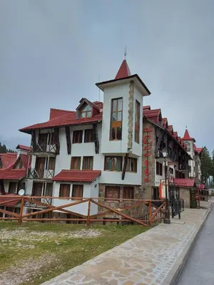 a large building with a red roof at Комплекс Замъка 2 ап 301 in Pamporovo