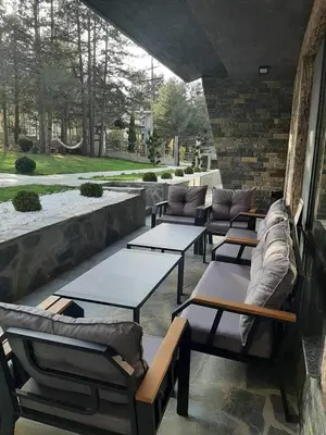 a group of tables and couches on a patio at Вила Bora Vista 1 in Tsigov Chark