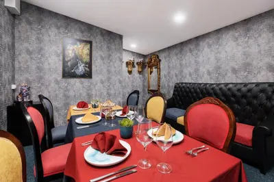 a dining room with a table with red table cloth and chairs at Art Magus Hotel in Sofia