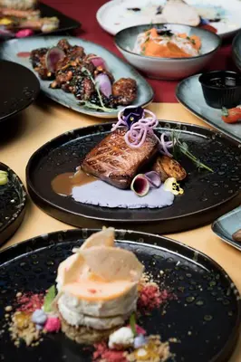 a bunch of plates of food on a table at Art Magus Hotel in Sofia