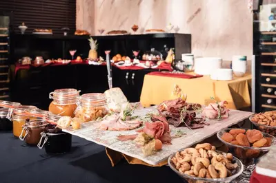 a table filled with different types of food on at Art Magus Hotel in Sofia