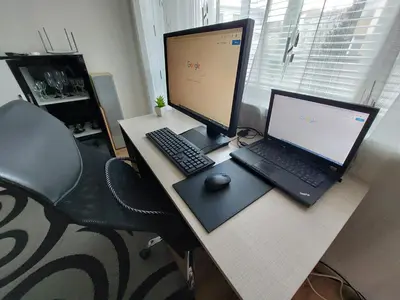 a desk with a laptop and a desktop computer on it at 3 Rooms Apartment, Top Center, 1st Floor Flat, AUBG, WiFi, PC i5 SSD, Tablet, AndroidMiTvBox, 3 LED TVs 200 Channels, Long Terrace, Self-Easy-Late Check-in, Stay Before Greece in Blagoevgrad