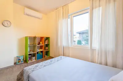 a bedroom with a bed and a window at Вила Ибър село Радуил in Raduil