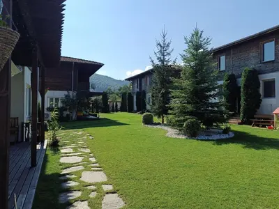 a yard of a house with a green lawn at Вила Ибър село Радуил in Raduil