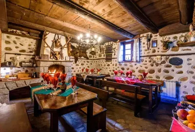a dining room with tables and chairs in a building at Chalet Mila - Total Chalets - Fully Catered in Bansko